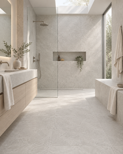 Natural minimalist spa bathroom with LIMESTONE Pearl porcelain tile, skylight and pale wood vanity